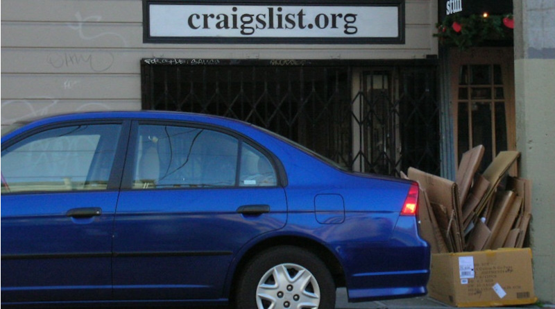 A blue Honda Civic parked in front of a Craigslist location