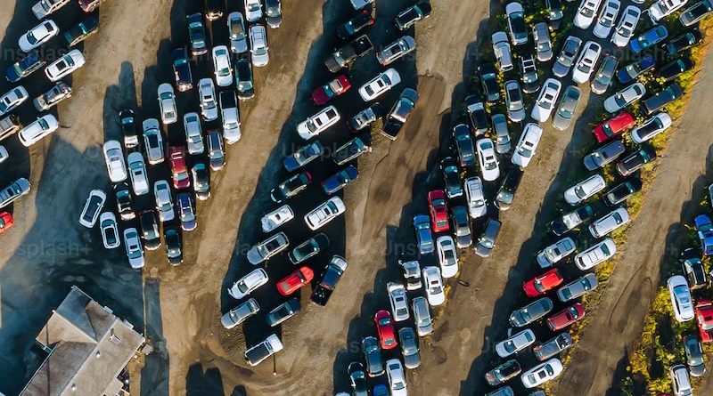 An aerial view of a parking lot with numerous for-sale vehicles